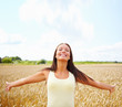 Cute female with her hands raised out in the open farm
