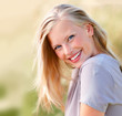 Sweet young female smiling outdoors