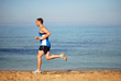 Man running along the beach