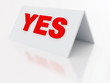 sign yes on a light plastic tablet on a white background