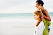 Happy family on a beach vacation, walking on the sea shore