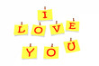 Yellow paper pinned to a white background with inscription "I lo