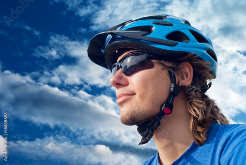 portrait of a young bicyclist in helmet and glasses portrait of a young bicyclist in helmet and glasses