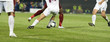 Soccer players running after the ball