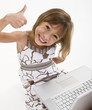 Photo: A young girl playing on a laptop A young girl playing on a laptop