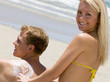A Beautiful Woman Applying Lotion on a Man