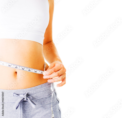 Photo: Young Woman Measuring Herself On White Young Woman Measuring Herself On White