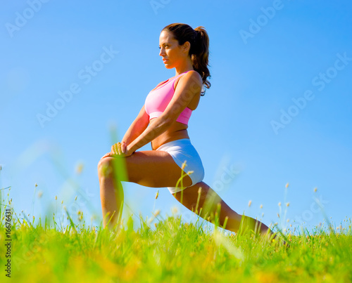 Photo: Athletic Woman Exercising Athletic Woman Exercising
