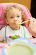 Toddler eating spinach