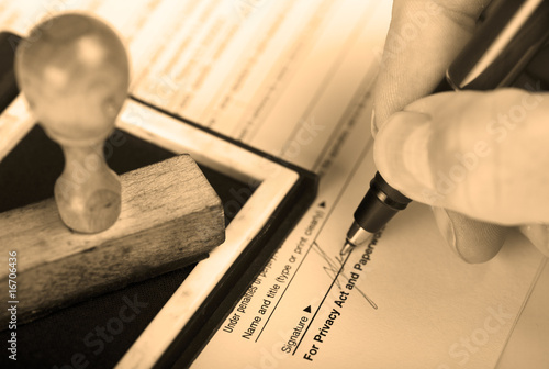 Photo: Signature with stamp on inkpad. Sepia toned Signature with stamp on inkpad. Sepia toned