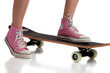 Photo: Young girl skateboarding with pink sneakers Young girl skateboarding with pink sneakers