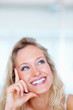 Closeup portrait of a young girl smiling, looking upwards