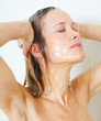 Cute young woman taking a shower