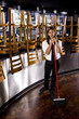 Photo: Hispanic bartender sweeping closed bar area Hispanic bartender sweeping closed bar area