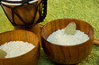 wooden bowls with rice and tamtam on green wooden bowls with rice and tamtam on green