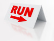 sign run with arrow on a light plastic tablet