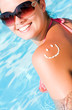 A smile made with suncream at the shoulder
