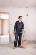 Man mixing plaster in house under construction