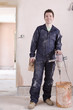 Man mixing plaster in house under construction