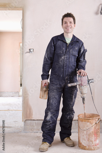 Photo: Man mixing plaster in house under construction Man mixing plaster in house under construction