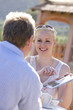 Photo: Couple looking at travel guidebook on cafe patio Couple looking at travel guidebook on cafe patio
