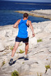 Man sprinting along rocks