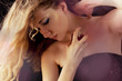 beautiful blond woman applying perfume on her body beautiful blond woman applying perfume on her body