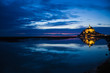 Mont St. Michel reflected in the sea at night Mont St. Michel reflected in the sea at night