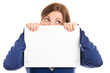 Worried woman covering face with blank notecard