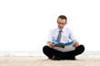 a businessman sitting and reading newspaper near the sea