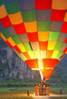 Hot air balloon warming up before taking off, at dawn