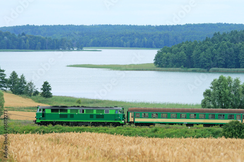 Photo: Passenger train passing through the lakeside Passenger train passing through the lakeside