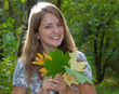 Young pretty woman with the autumn leaf