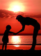 Silhouettes of the women and child on sundown Silhouettes of the women and child on sundown