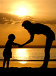 Silhouettes of the women and child on sundown Silhouettes of the women and child on sundown
