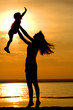 Silhouettes of the women and child on sundown Silhouettes of the women and child on sundown