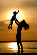 Silhouettes of the women and child on sundown Silhouettes of the women and child on sundown