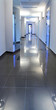 Corridor in a hospital building, with the doctor at the end