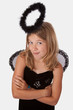 Cute little girl in a dress with wings and black halo