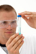 male lab technician looking at test tube