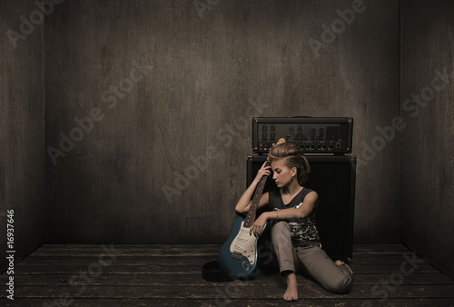Photo: Girl with guitar in a vintage room Girl with guitar in a vintage room