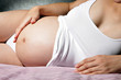 Pregnant woman in bed.