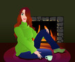 Woman with cup of tea sitting near fireplace