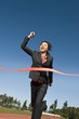 Businesswoman Crossing the Winning Line