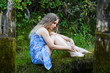 Sad young woman relaxing on nature.