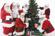 Group of men dressed as Santa Claus decorating Christmas tree