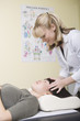 Medical practioner applies pressure to skull