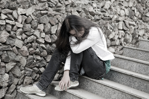 Photo: Teens problems. Young woman alone at the city Teens problems. Young woman alone at the city
