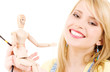 happy teenage girl with wooden model dummy