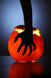 Hand over Halloween pumpkin